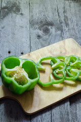 Photo of sliced peppers over wooden table