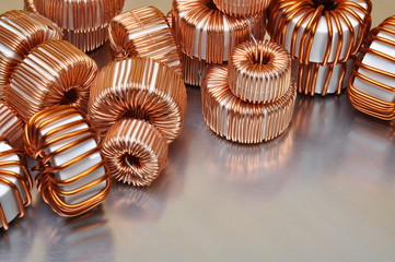 Electric copper coils on metal background 