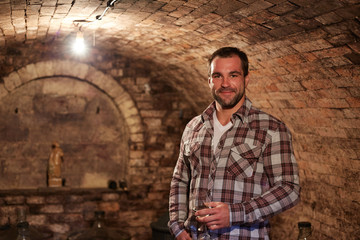 Man in wine cellar