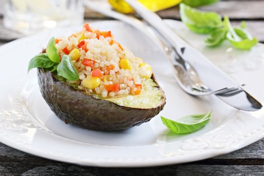 Grilled avocado staffed with quinoa vegetables  salad.Selective focus