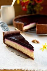 Homemade chocolate cream tart with blackberry jelly and walnuts