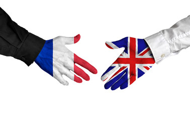 France and United Kingdom leaders shaking hands on a deal agreement