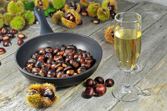 Roasted chestnuts with glass of white wine