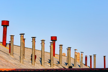 Old steel chimneys on the roof.