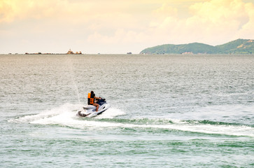 Fototapeta na wymiar People riding jet ski in the sea