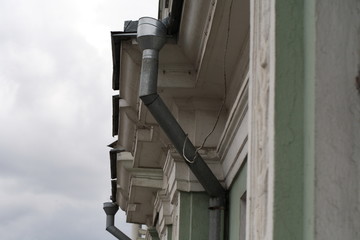 tin galvanized downspout from the roof of the building