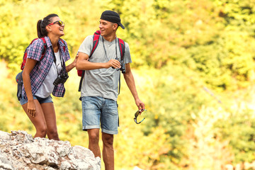 Young couple hiking and climbing at the mountain