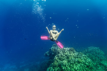 young woman snorkling under water