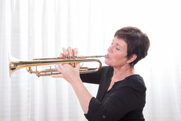 attractive woman playing the trumpet