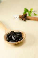 bean on wooden spoon on wood board background