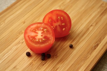 tomatoes with black pepper on the board with knife