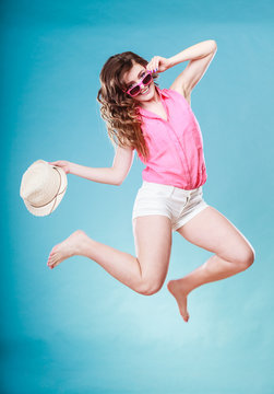 Summer woman in straw hat jumping