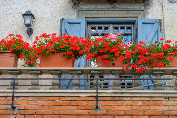 Fototapeta na wymiar Cute mediterranean balcony with flowers
