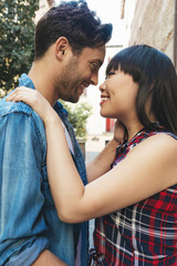 Portrait of happy beautiful couple isolated on street