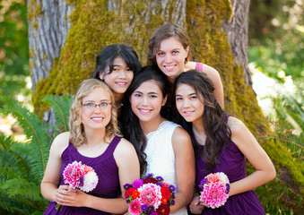 Beautiful biracial young bride smiling with her multiethnic grou