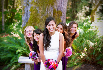 Beautiful biracial young bride smiling with her multiethnic grou