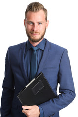 Attractive businessperson standing in a blue suit and tie holding a clipboard. White background.