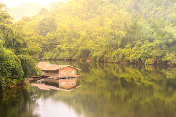 Obraz premium Raft house in Kwai river spring seasonal at Kanchanaburi, Thailand.