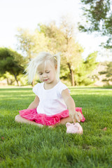Fototapeta premium Little Girl Having Fun with Her Piggy Bank Outside
