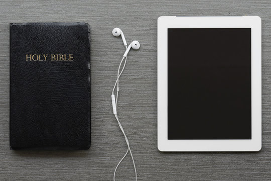 Contemporary image of the Bible and tablet.