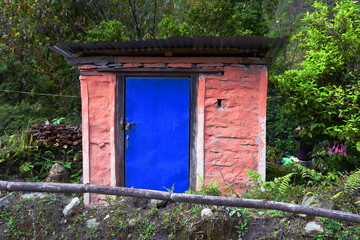 Fototapeta na wymiar closed up the blue wood door with brick wall, in village Nepal