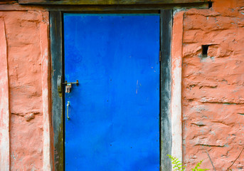 closed up the blue wood door with brick wall, in village Nepal