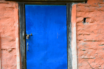 closed up the blue wood door with brick wall, in village Nepal
