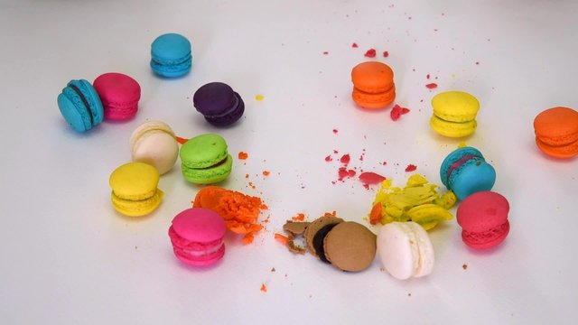 ็Hand smashing and beating colorful macaron (macaroon) dessert food and destroy crush it with anger into little pieces on white isolated background on 1920x1080 HD quality video.