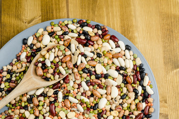 legumes in a dish on wood, close up, background