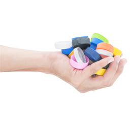 Hand holding many colorful  bottle cap of water on white backgro