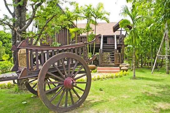 Thai house style and Old farmer wooden cart in Thailand.