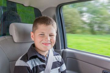 Teenager sitting in a car in safety chair