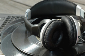 Fototapeta na wymiar player with headphones on vinyl plates