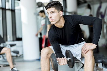 Fototapeta premium Young man training in a gym