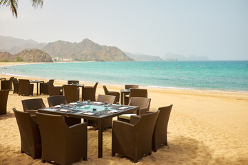 tropical restaurant on the beach with view over turquoise ocean