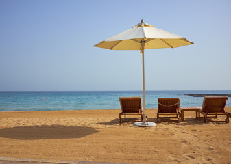 empty sun loungers on the beach