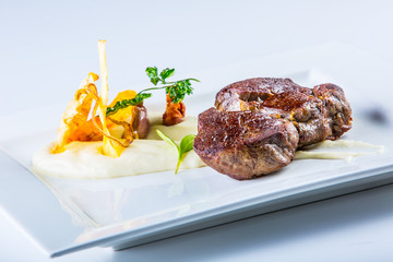 Rump steak. Close up Tender Grilled Beef Meat on White Plate with vegetable decoration.  