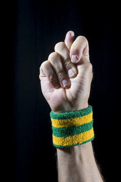 Brazilian good luck hand sign known as the figa with the thumb poking between fingers of a fist