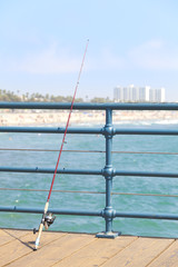 Fishing rod on pier, Santa Monica, USA.