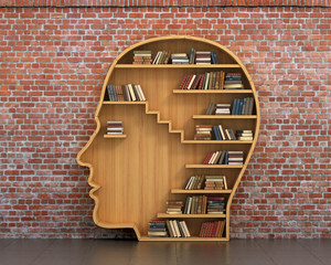 Concept of training. Wooden bookshelf full of books in form of m - obrazy, fototapety, plakaty