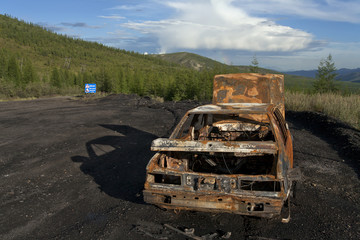 Burned car in the Kolyma road.
