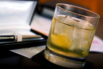glass with whiskey and ice at the office