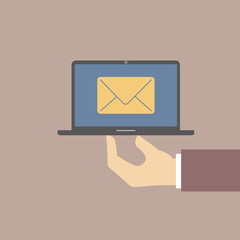 online letter on the laptop screen. hand holds laptop