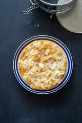 Homemade tart with apricot jam and almond slices