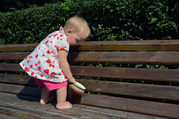 a cute toddler girl and a pot in her hands