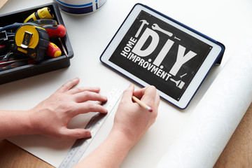 Man Plans Design Project Using Application On Digital Tablet