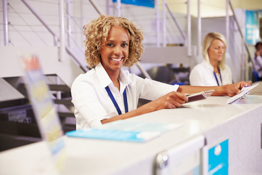 Portrait Of Staff At Airport Check In Desk