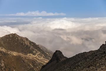 Naklejka premium peaks of mountains above the clouds