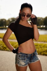 Portrait young sexy swag fashion style girl posing at city park