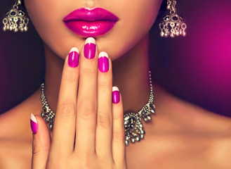 Crimson manicure and make-up , lip color fuchsia . Indian style silver jewelry ,earrings and necklaces - obrazy, fototapety, plakaty